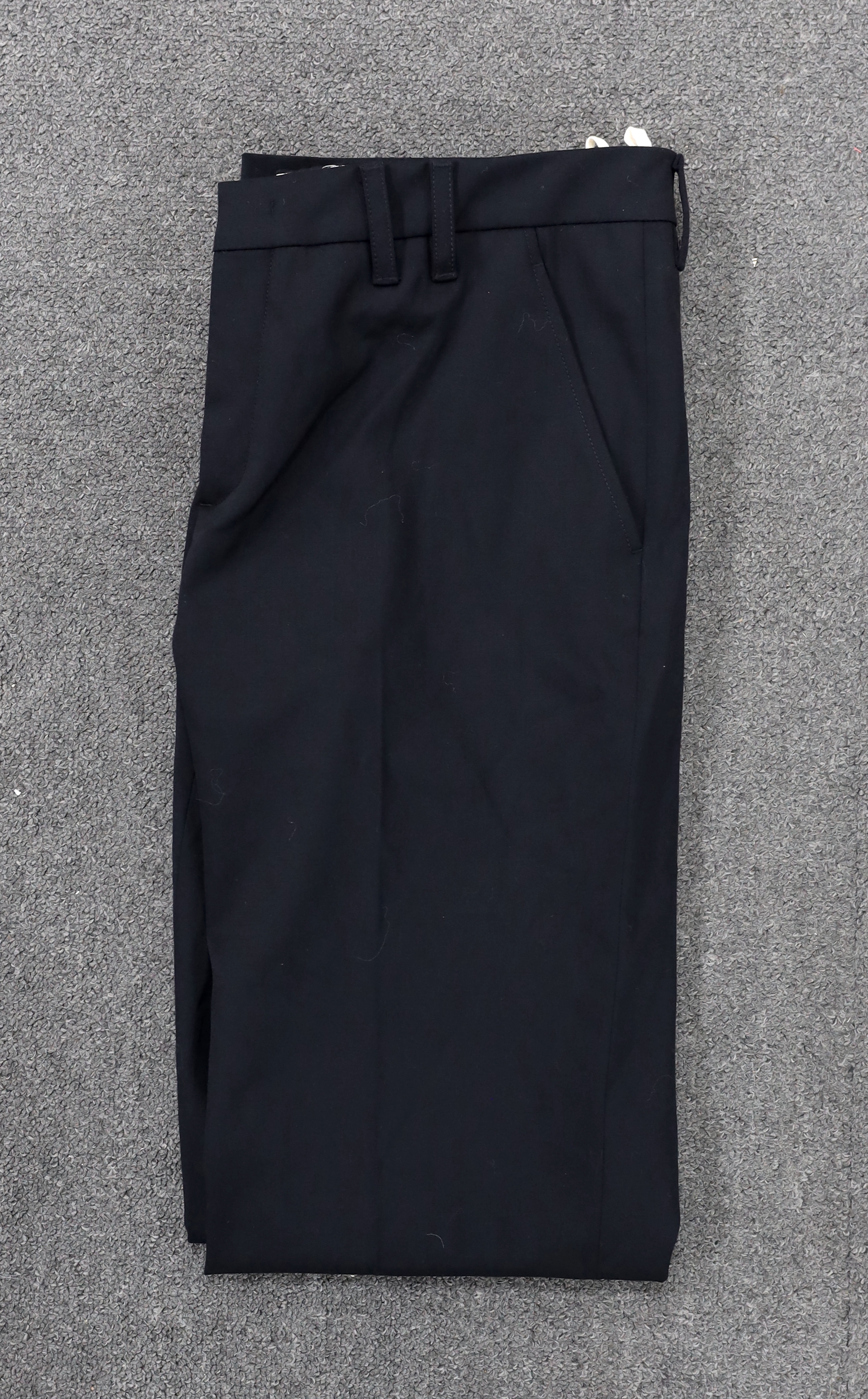A Prada black A line wool skirt with silver embellishment on the pockets, a blue cotton canvas short swing raincoat and a black pair of wool suit trousers, all size 42